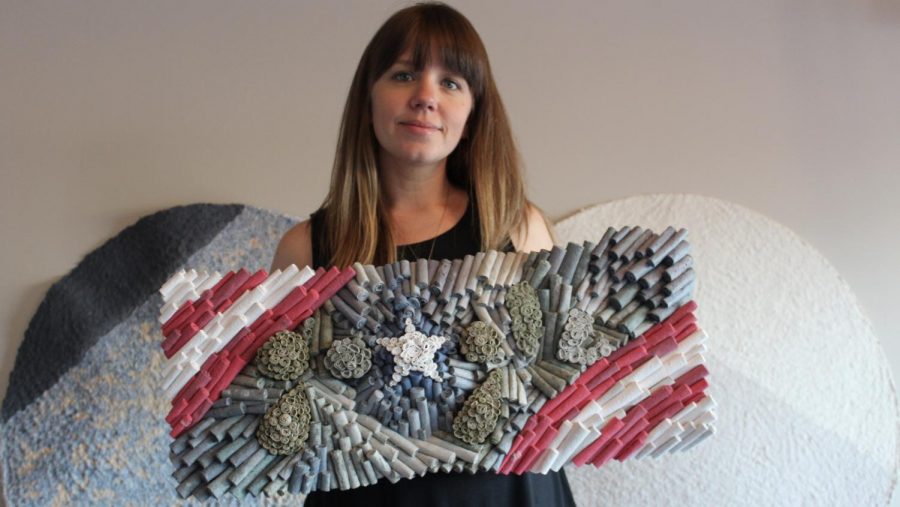 Jenn Hassin poses with her completed work. Veterans Day is observed annually on Nov 11 and honors all who have served in the US Armed Forces. 