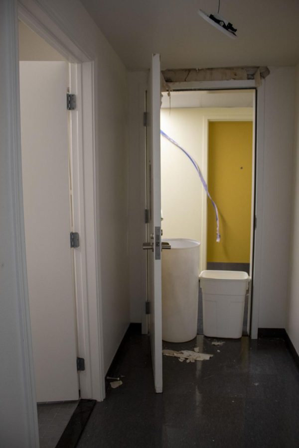 The water burst out of the wall above the exit door in Isabel Garcia's apartment, damaging the wall and ceiling above. Garcia described it as a "bubble that burst." 