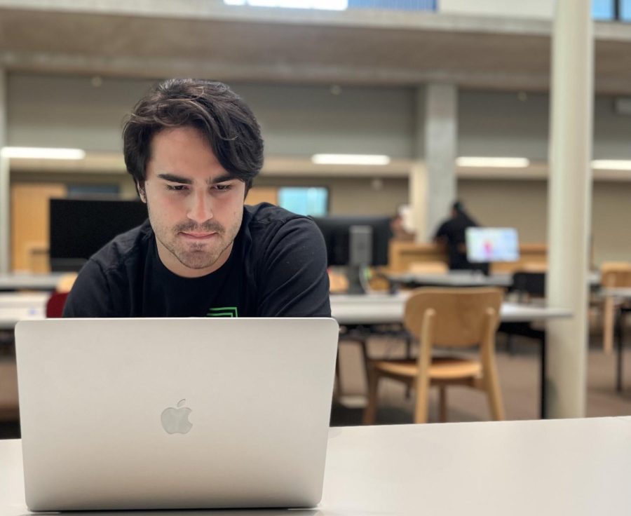 Junior Bryce Johnston sits at a hightop in Munday Library working on assignments and other personal projects. The Munday Library is one of the many facilities students get to appreciate while on campus. 