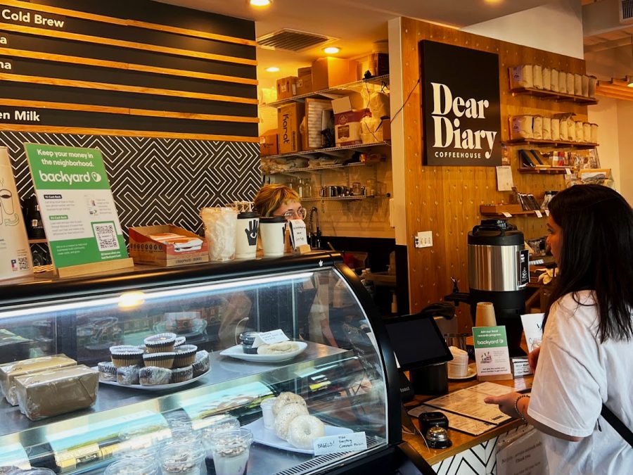 Lara ordering coffee at Dear Diary Coffee's register.
