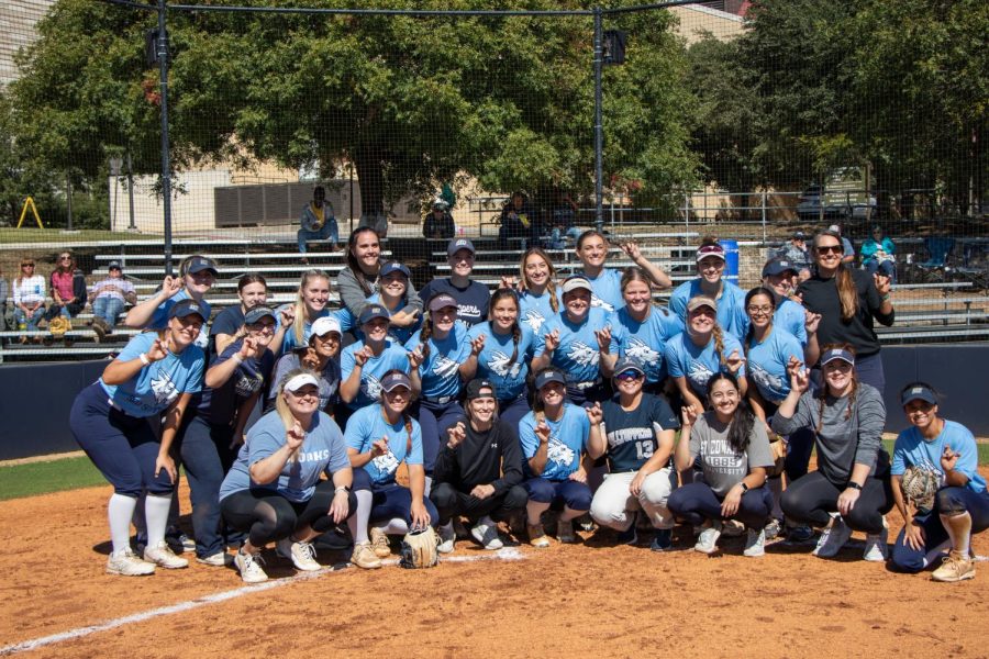 Team+players+pose+for+a+photo+with+current+Hilltoppers+and+alumni+from+past+seasons.+