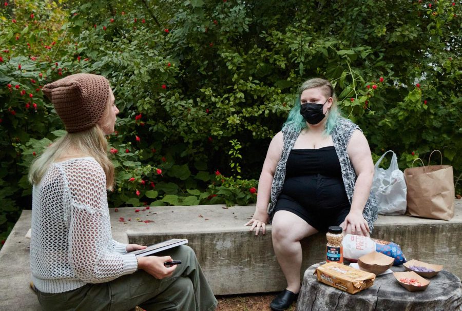 Dorian Hardgrove (right) and Grace Hartung-Latham (left) share their interests and beliefs before the event officially began. Hardgrove hosted this celebratory ritual just before dusk to bring together fellow pagans to celebrate Samhain, though the event wasn’t exclusive to just pagans.