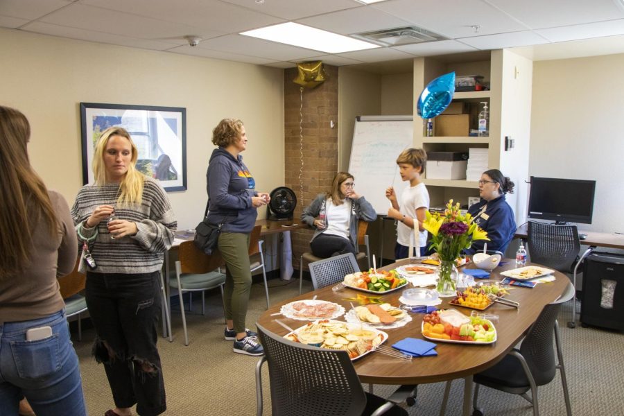 Those attending the opening house hang out in the lobby and enjoy snacks.