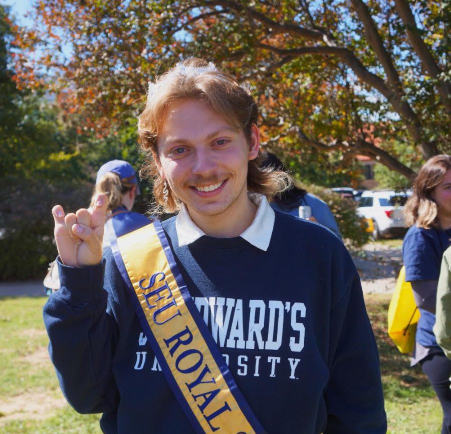 Benoit poses for the camera with his toppers up and sporting an "SEU Royal" banner. This is his second time on homecoming court.