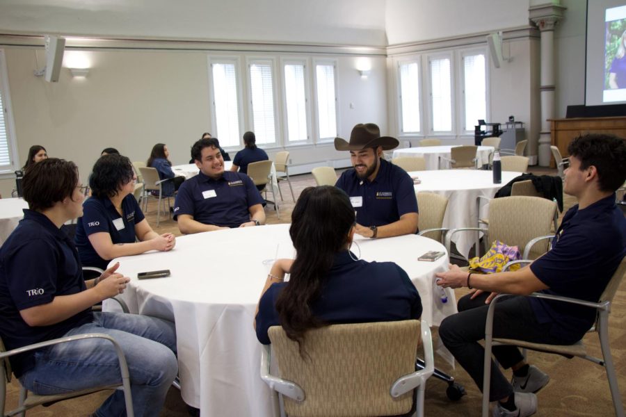 Pedro Galvan (wearing a cowboy hat) talking to scholars (clockwise order): Diego Garza (cohort 2021-2022), Aaliyah Gutierrez-Cano (cohort 2022-2023), Milo Dufresne-Macdonald (2022-2023), Makena Gonzalez (2021-2022), and Diogo Ledesma (2022-2023). 