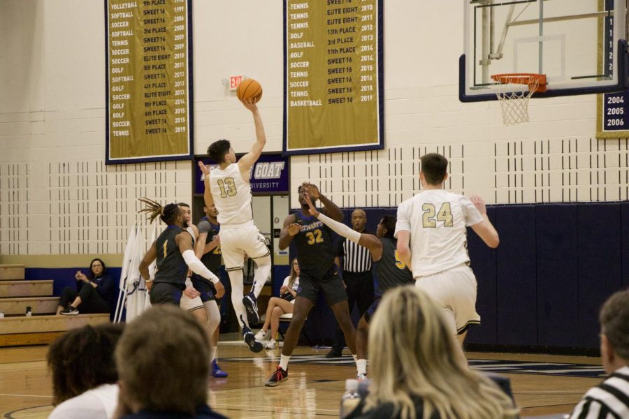 Sophomore Gavino Ramos jumps smoothly in a two-pointer, one-handed shot among the Rattlers pressuring defense.