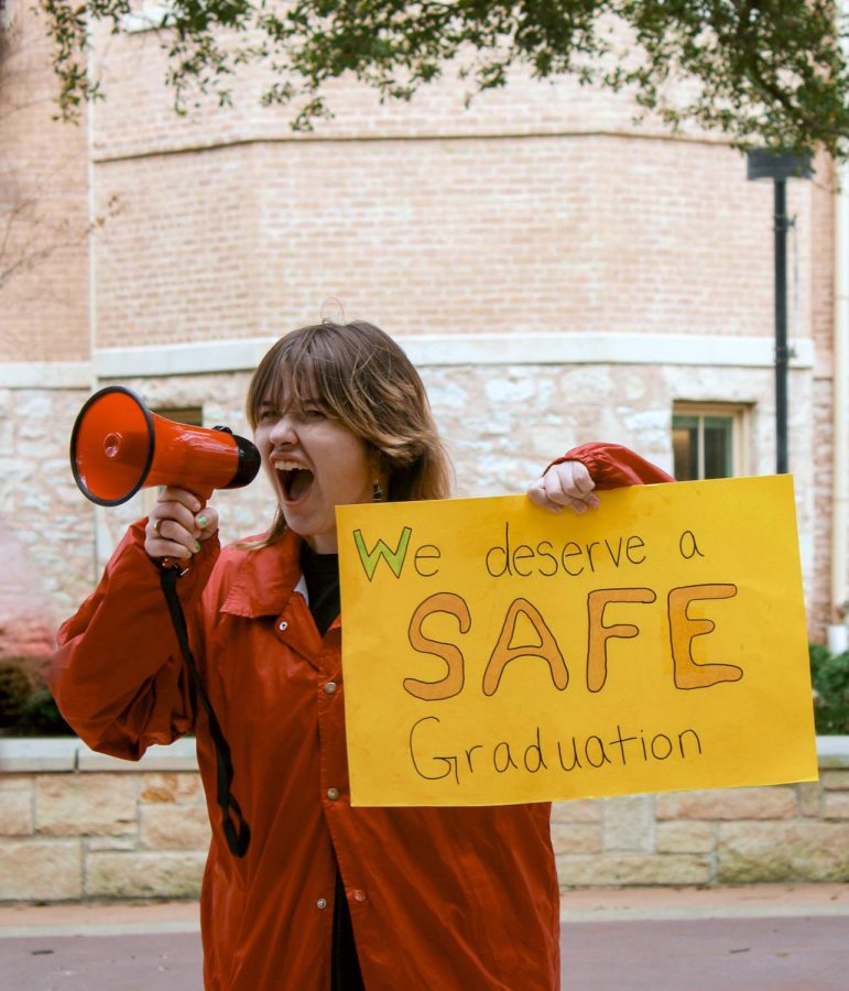 Senior Bri Boughter leads a chant at the graduation protest, leading a chant about wanting a safe graduation. Boughter stood in the middle of the seal at the Ragsdale plaza, as she and other protesters chanted along.