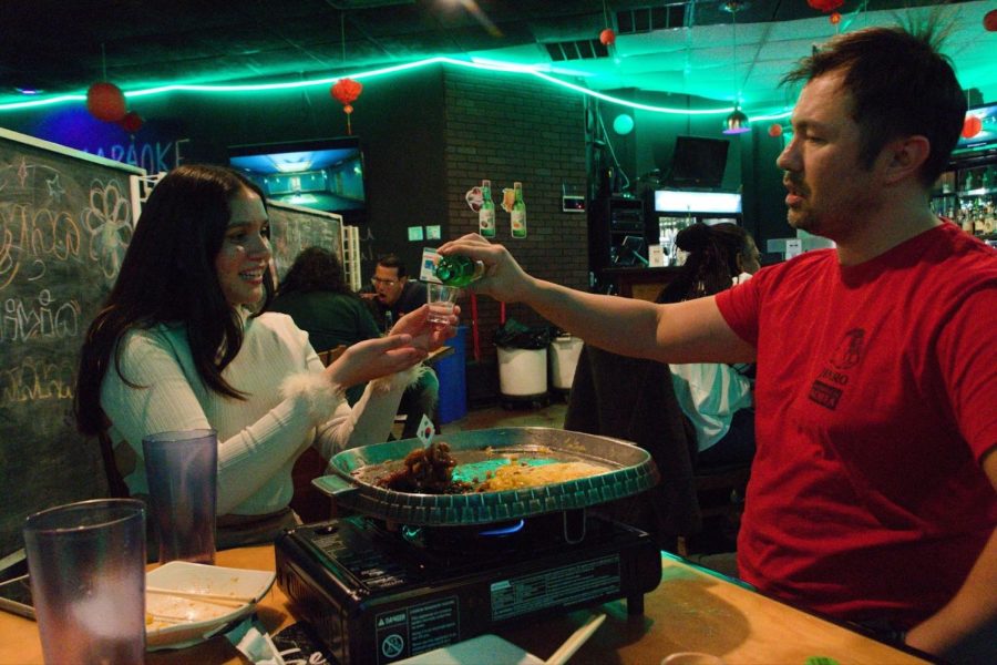 Lee teaches me the traditional Korean method of pouring a shot.