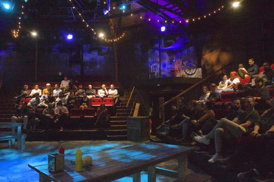 The stage is set; during the second week of the shows premiere, MMNT enthusiasts gathered in the crowd and anticipate the shows start. Soft blue lights dimly light the stage's floor, with set pieces and props ready for use. 