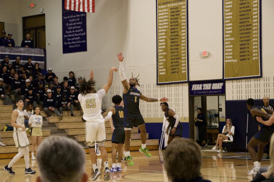 Dibiamaka (left) taking a shot on the courts of St. Edward's during a game against St. Mary's.