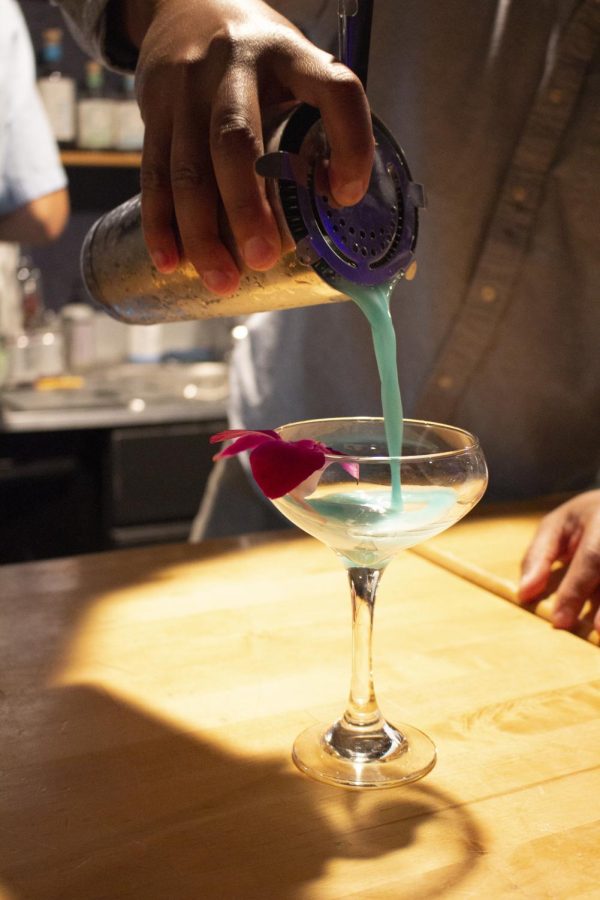 Sans Bar owner Chris Marshall pours out the Nada Colada, a non-alcoholic pina colada made blue.