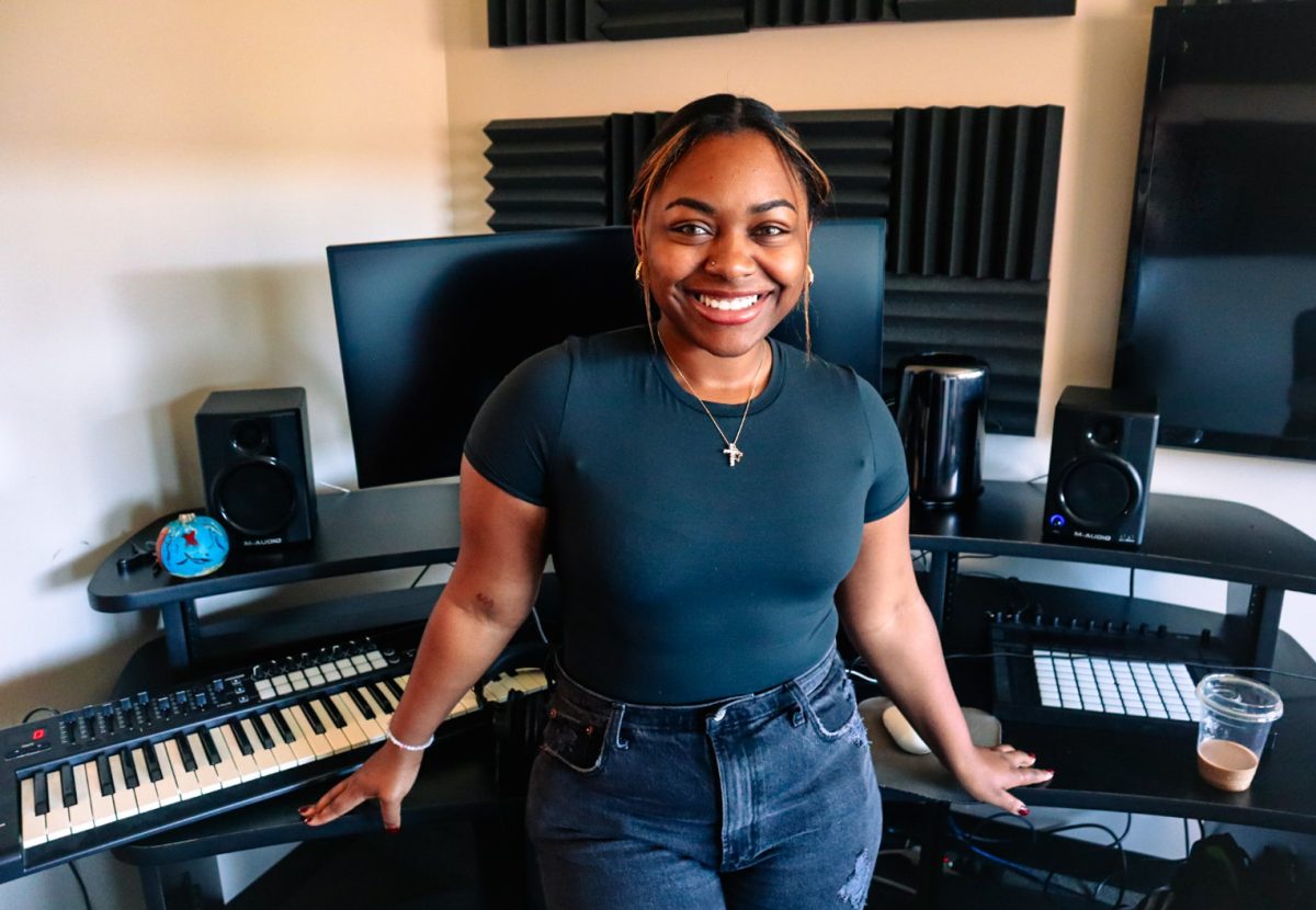 Tatianna Holdman AKA Tatianna Cabana poses for a photo in the audio recording rooms in Munday Library. 