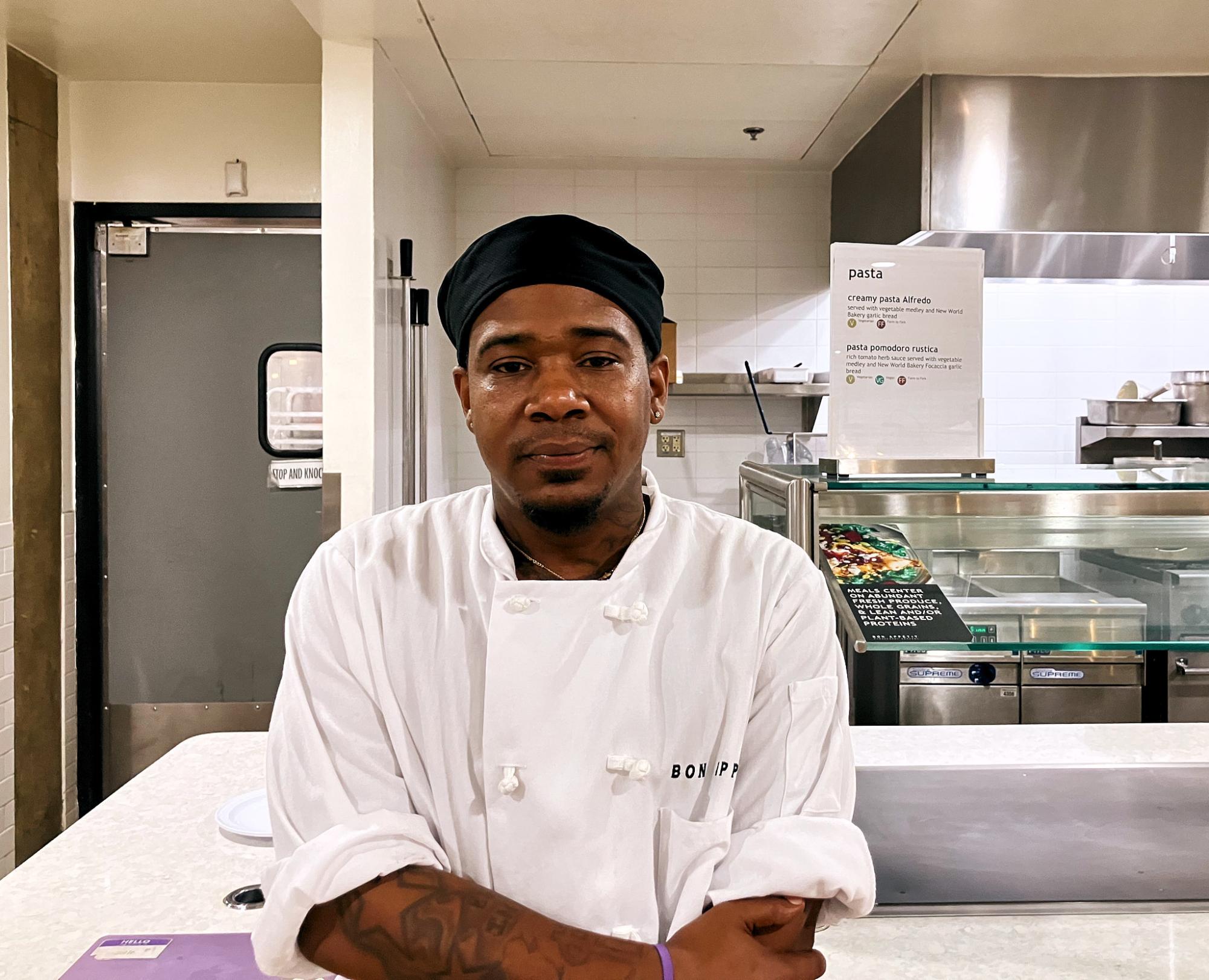 Quintin poses in front of his usual station in Hunt Hall where he works behind the line.