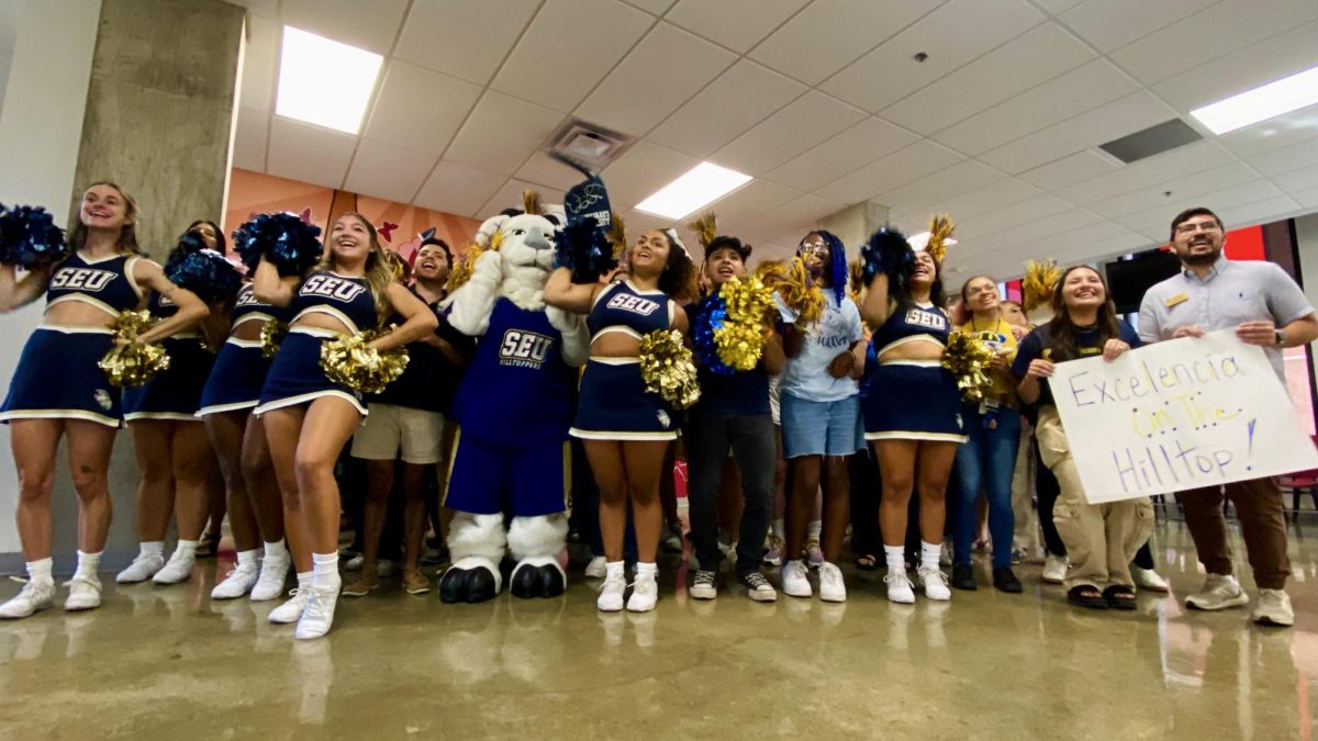 St. Edwards students in Hunt Hall cheer as they witness President Fuentes on the livestream receive the Seal from Washington D.C.