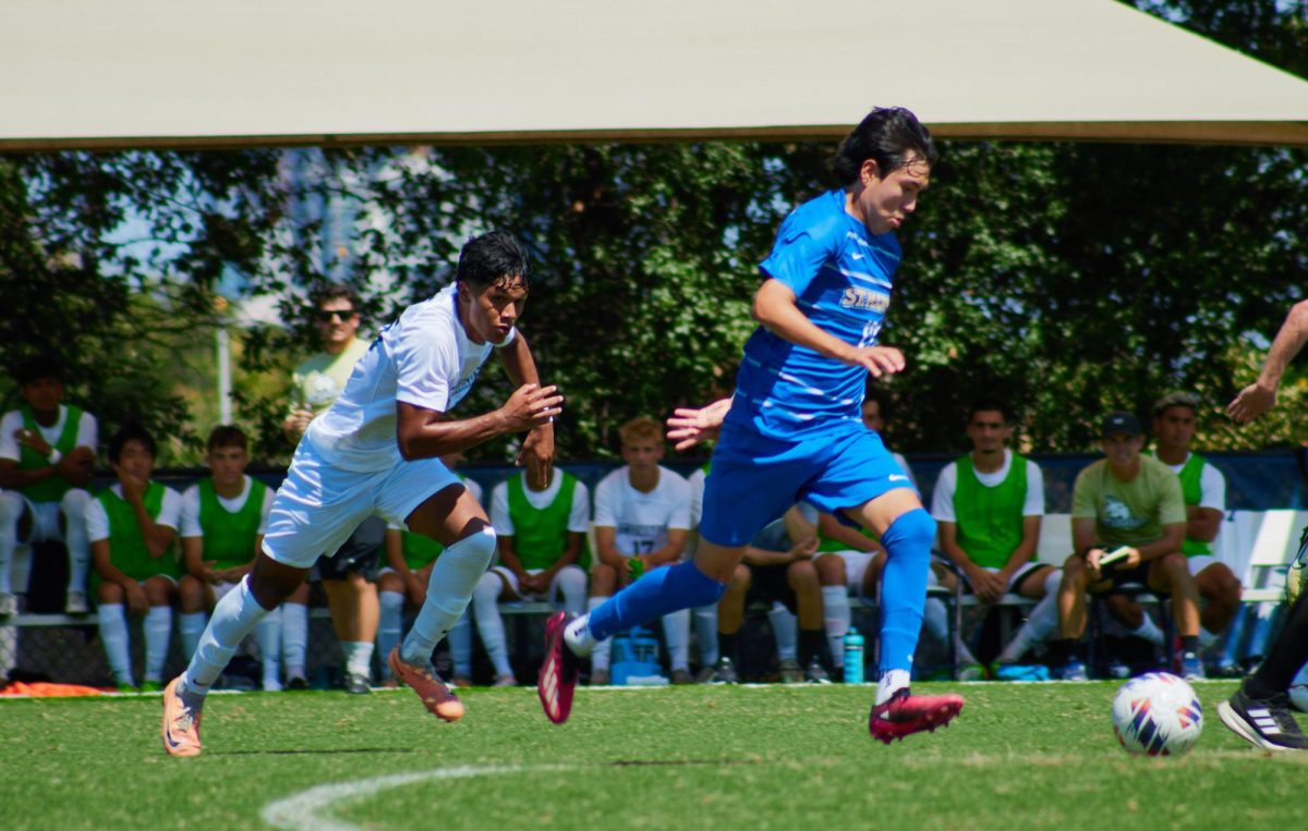 Junior midfielder Carlos Huato sprints for a ball dispute.