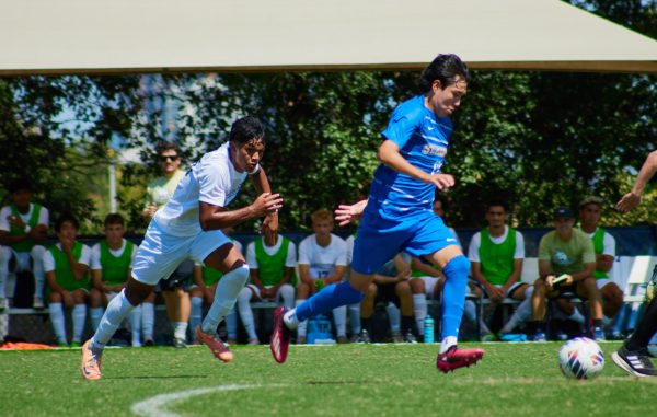 Junior midfielder Carlos Huato sprints for a ball dispute.