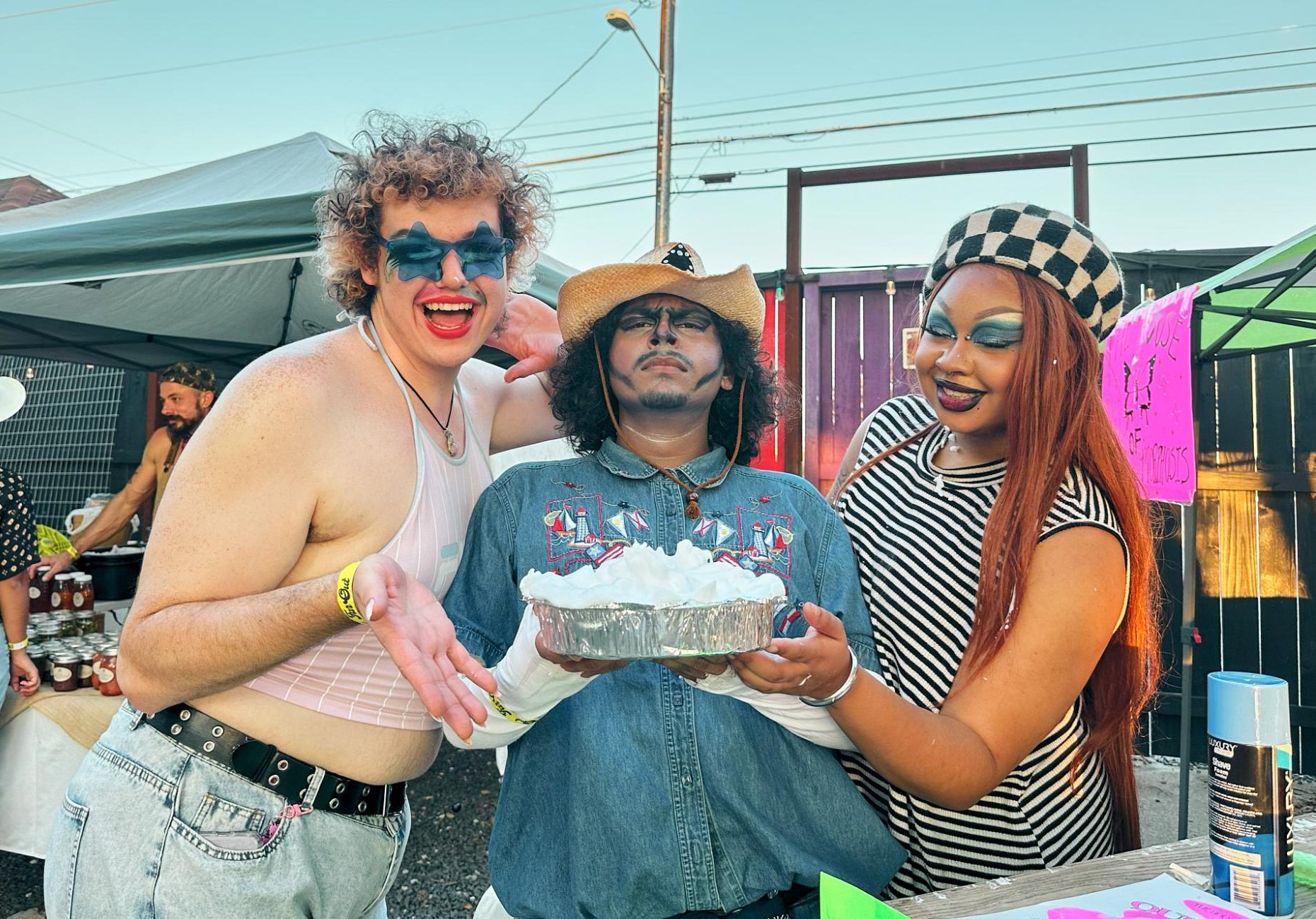 Members of the House of Metamorphosis pose for a picture at the Heel Country Fair awaiting to get pied for a charitable cause. The proceeds of their Pie a Queen booth goes toward creating a queer space in San Marcos, Texas.