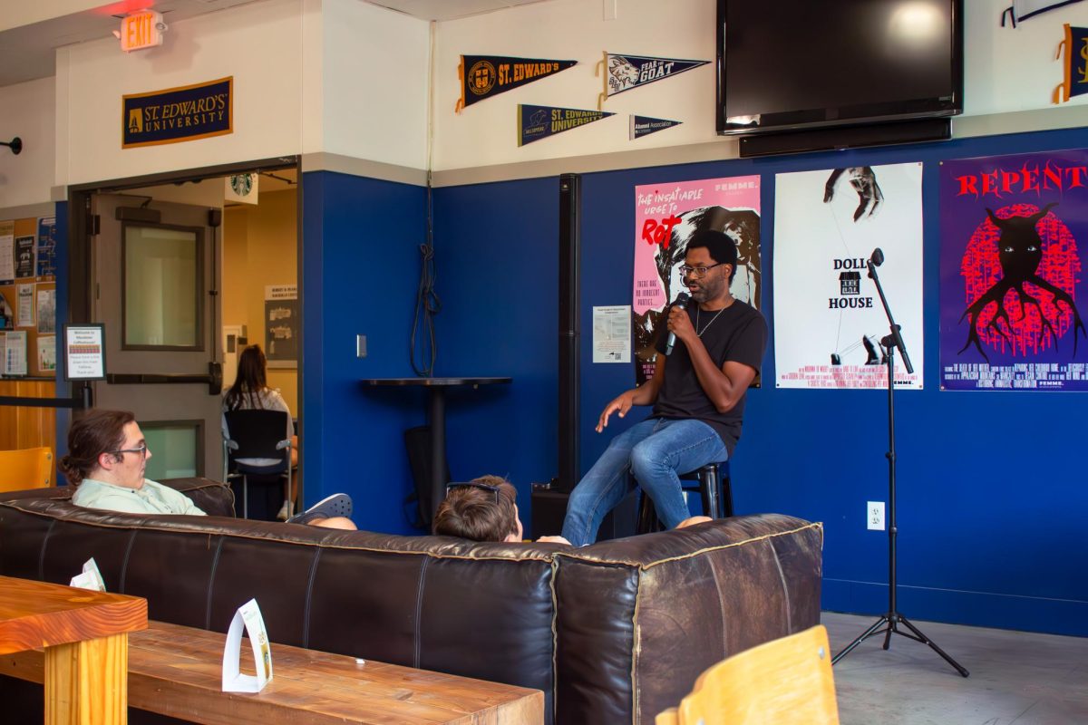 Both comedians stood in the front of the shop while spectators gathered at tables and on couches.