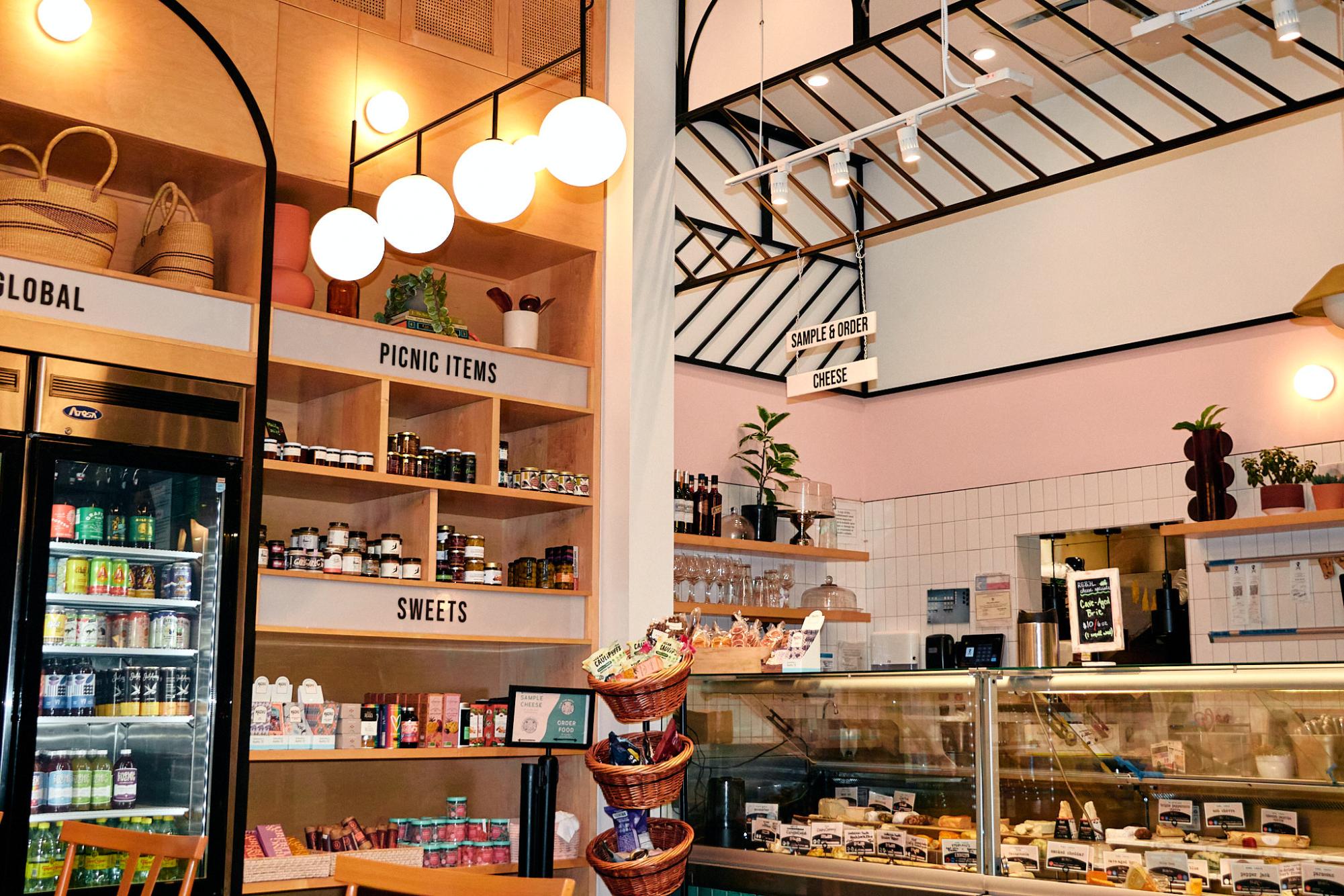 Rebel Cheese offers an aesthetically pleasing ambiance with their large assortment of vegan products and cheeses on display.