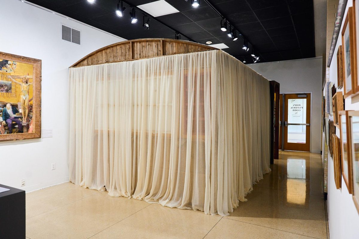 John Partick Cobbs eye-catching handmade wooden chapel takes center stage in the exhibit. Its size alone is grand and demands attention, alluring students to peek beyond the veil and discover the visual treasures it holds within. (Kennady Basdekis-Morin / Hilltop Views)