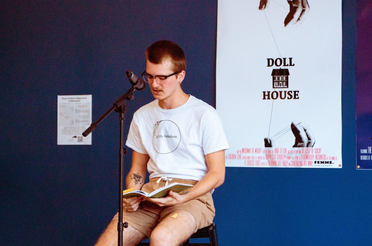Bradley+Burnett+reads+a+series+of+poems+in+front+of+the+crowd+at+open+mic+night+in+Meadows+Coffeehouse.