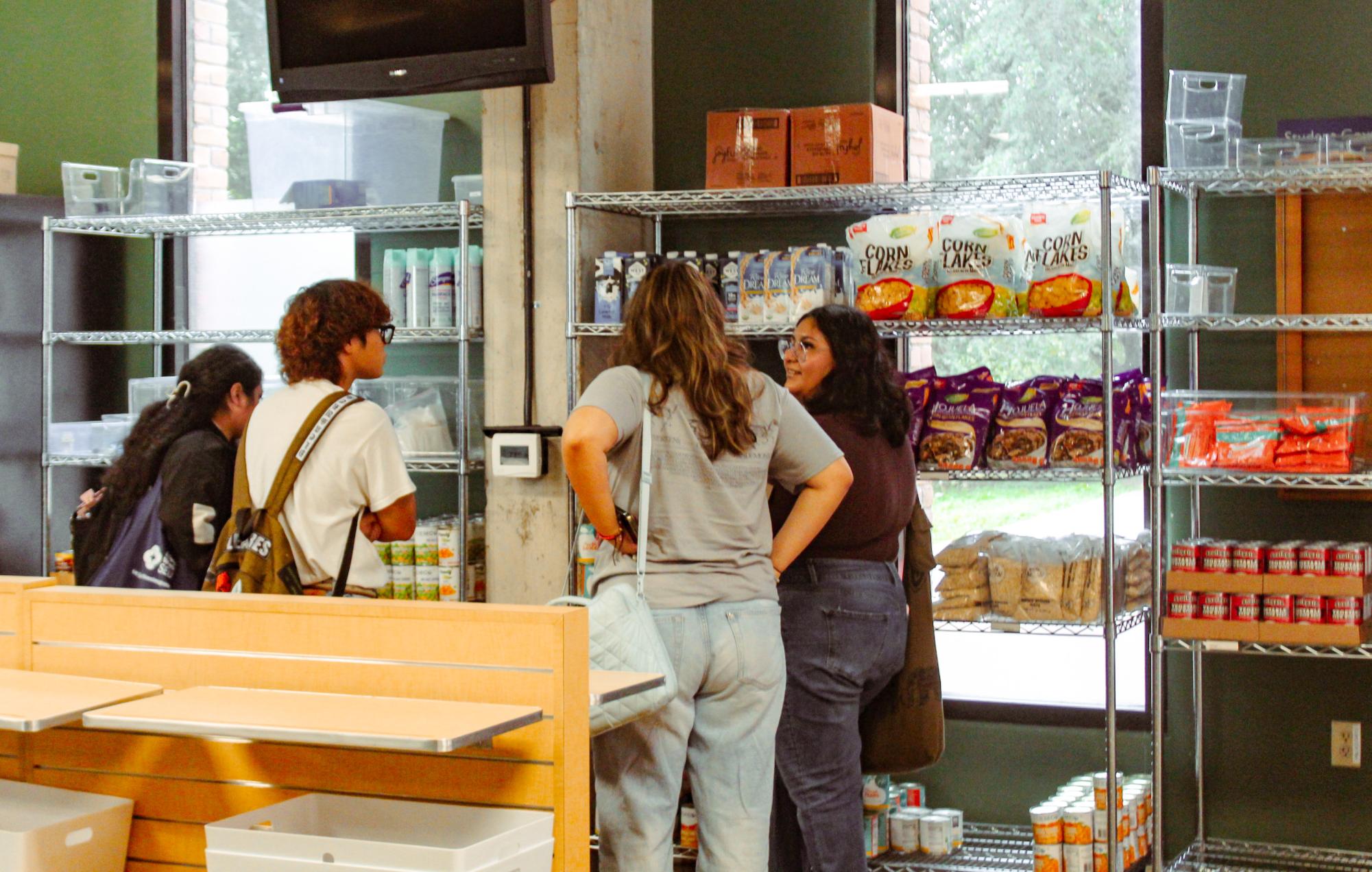 Students gather to view various dry food products placed throughout the pantry on shelves. The Huddle tends to have heavy foot traffic throughout the entire day.
