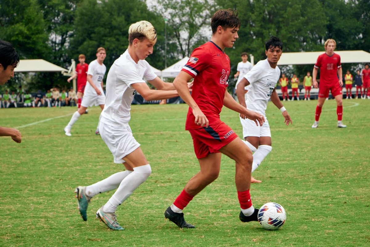 Freshman right back Cason Berg pressures DBU for possession.