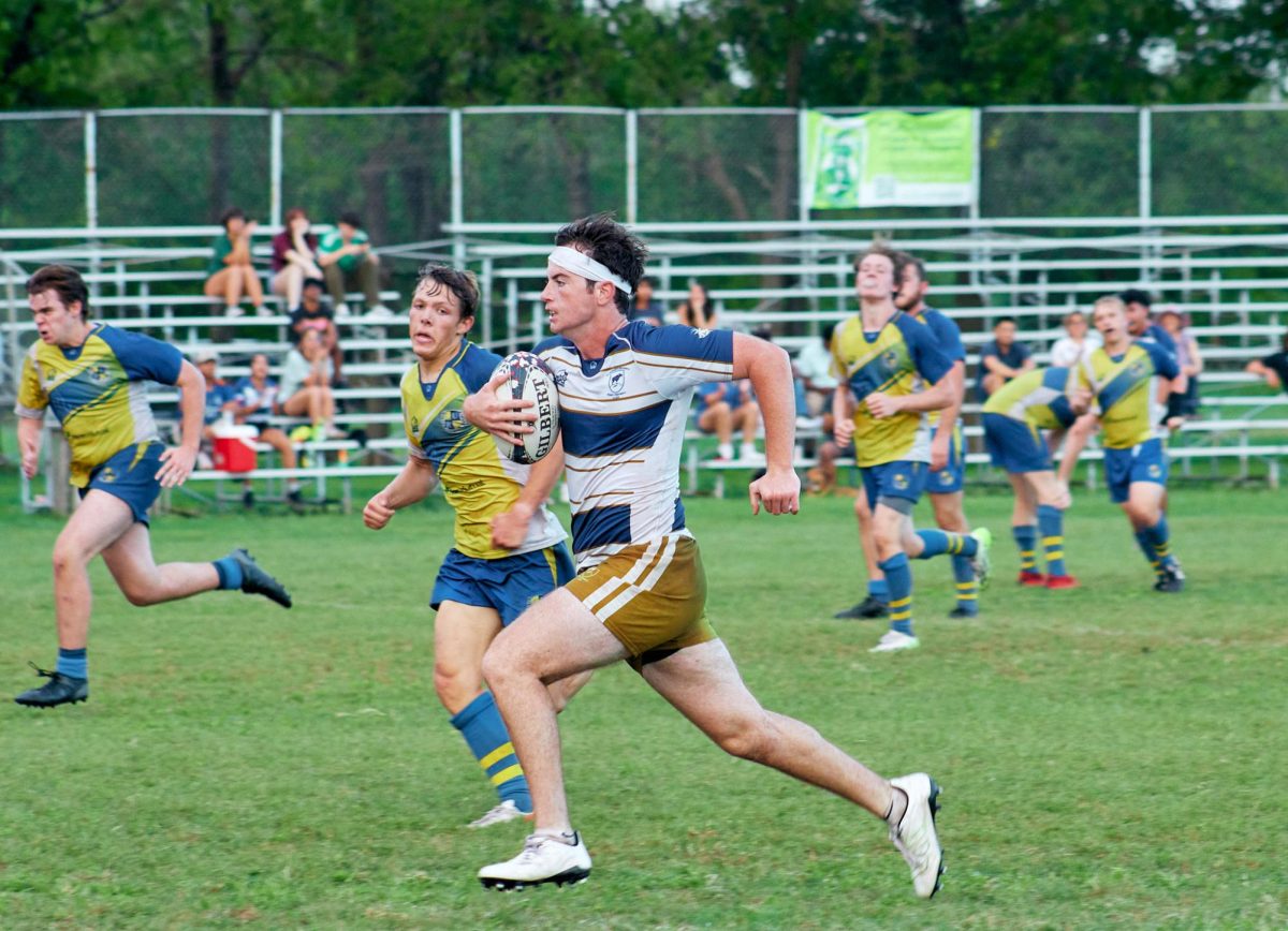 SEU Inside Center William Mayer aggressively moves the ball while being pursued by the LeTourneau players. Throughout the game, the Hilltoppers avoided the advances of the other team.
