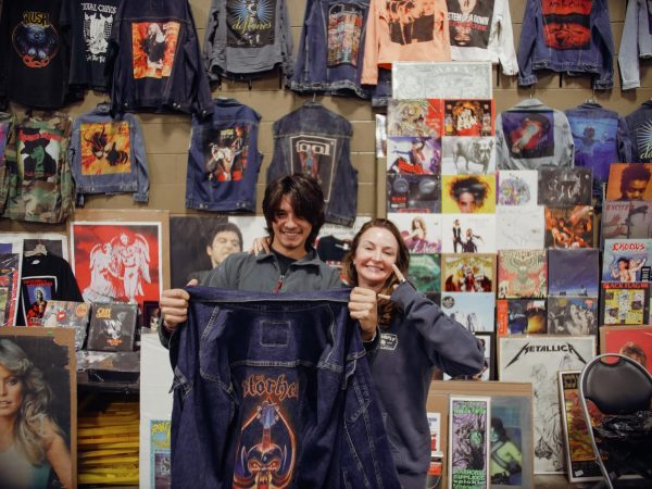 Born Late Records displays a custom Motörhead denim jacket in front of their booth. The company buys, sells and trades vinyl, CDs, tapes, shirts and other memorabilia. Their storefront is located at 2920 Race Street, Fort Worth, TX, and their Instagram is @bornlaterecords.