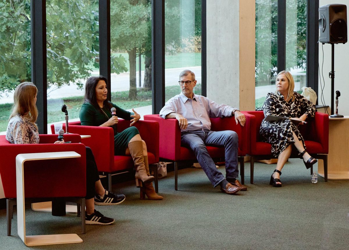 Kelleher, Houston, Hausenfluck and Edwards sit in armchairs addressing student attendees.