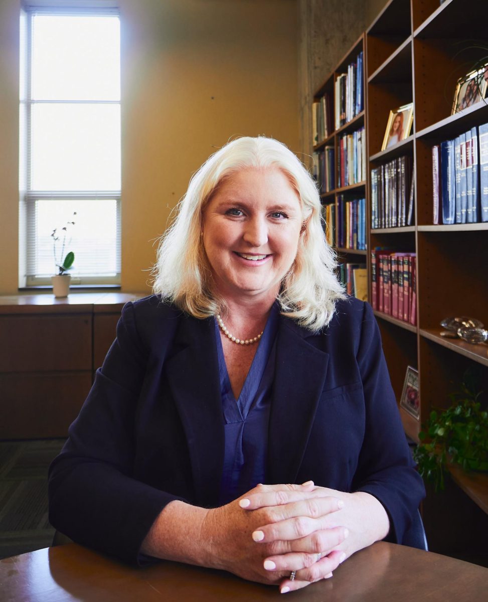 Alexis Stokes sits at a round oak table inside her office located on the third floor of Trustee Hall.
