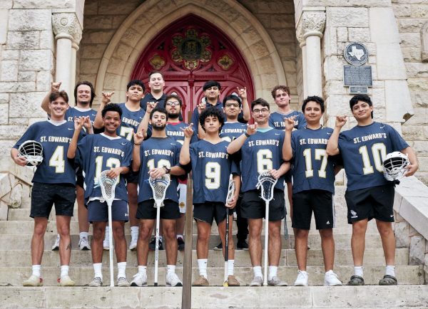 Men’s club lacrosse players pose in front of the red doors before their practice. Head coach and alumnus Tristan Garcia (center and back) leads practices and was a member of the championship team during his time as a student.