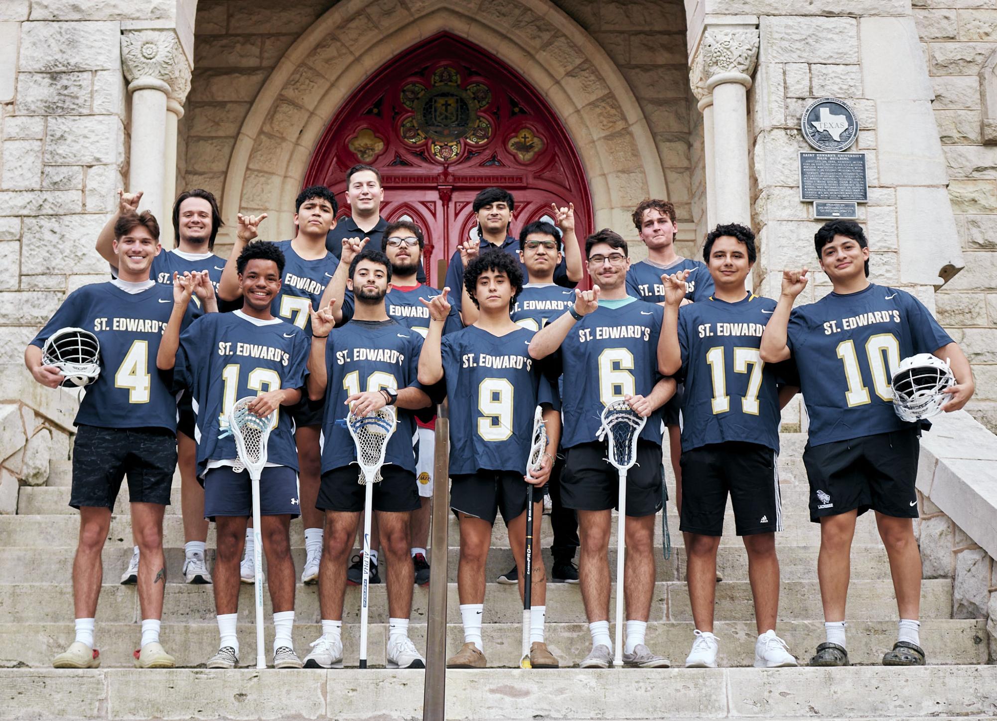 Men’s club lacrosse players pose in front of the red doors before their practice. Head coach and alumnus Tristan Garcia (center and back) leads practices and was a member of the championship team during his time as a student.