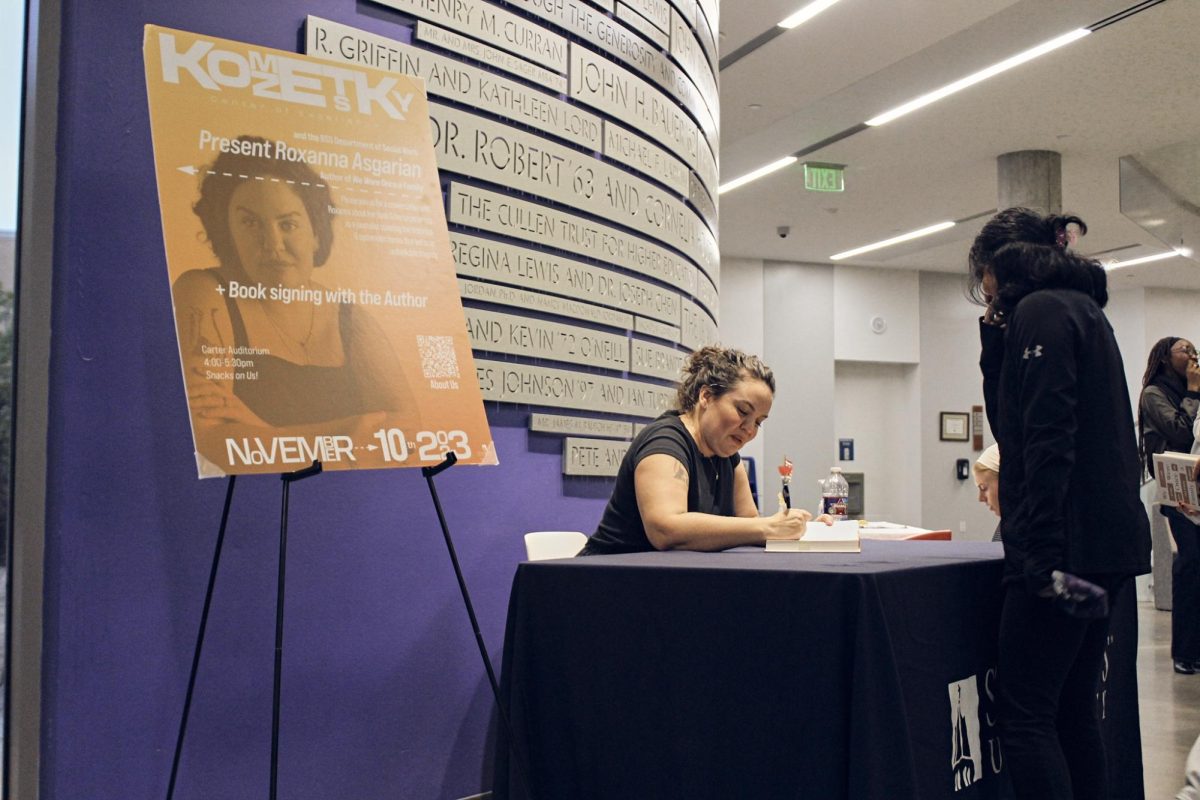 Author and journalist Roxanna Asgarian signs copies of her book after having a panel with students. Asgarian recommends for student journalists to do as many breaking news stories as possible to get a "first responder experience" and overcome fears.