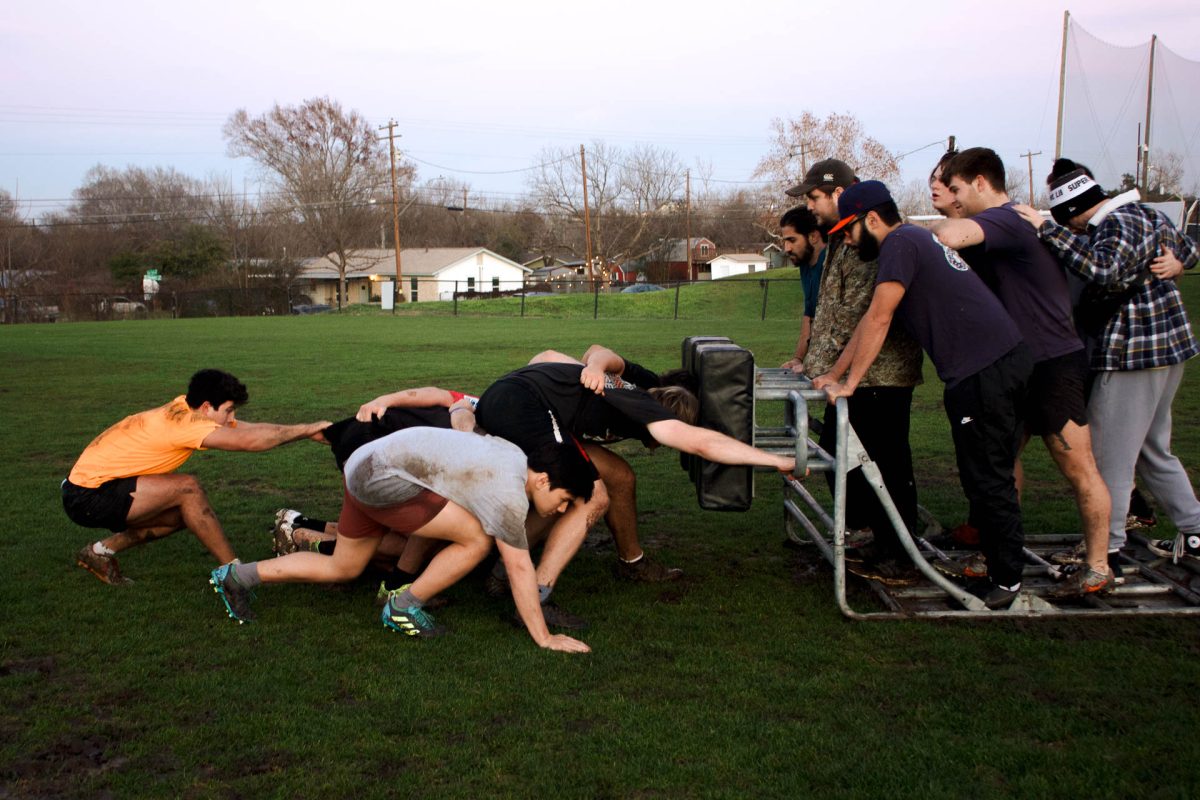 SEU+rugby+football+club+members+practicing+their+scrum+with+a+scrum+sled.+A+scrum+sled+is+meant+to+imitate+the+conditions+that+occur+under+a+scrum.+Several+coaches+and+other+people+stand+on+the+scrum+sled+to+model+the+weight+of+eight+people.
