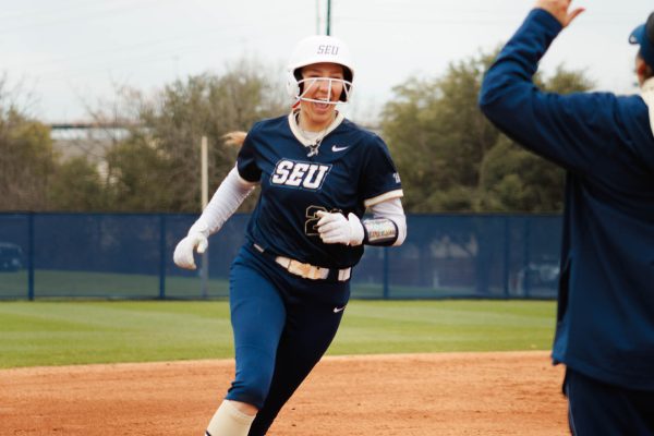 Ella Hutzler rounds the bases after hitting a two-run home run in the first inning of St. Edward’s 5-3 win over Texas A&M - Kingsville.