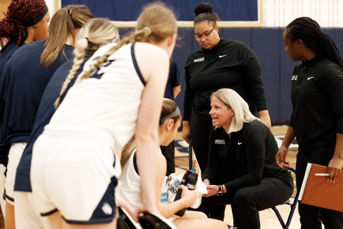 St. Edward’s Head Coach J.J. Riehl speaks to her team during a timeout against Lubbock Christian. Riehl is in her 12th year at the helm of the women’s basketball program, following her four-year career as a player on the Hilltop.