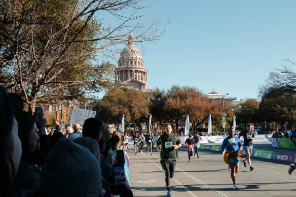 A series of half marathon finishers. With the State Capitol Building in the background, the marathon has a sense of grandeur worthy of the Lone Star State. The divider to the right separates the half marathon finishers from the full.