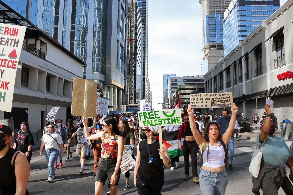 An angle of the march in downtown Austin. Protesters raised their signs high and chanted throughout the entire rally.