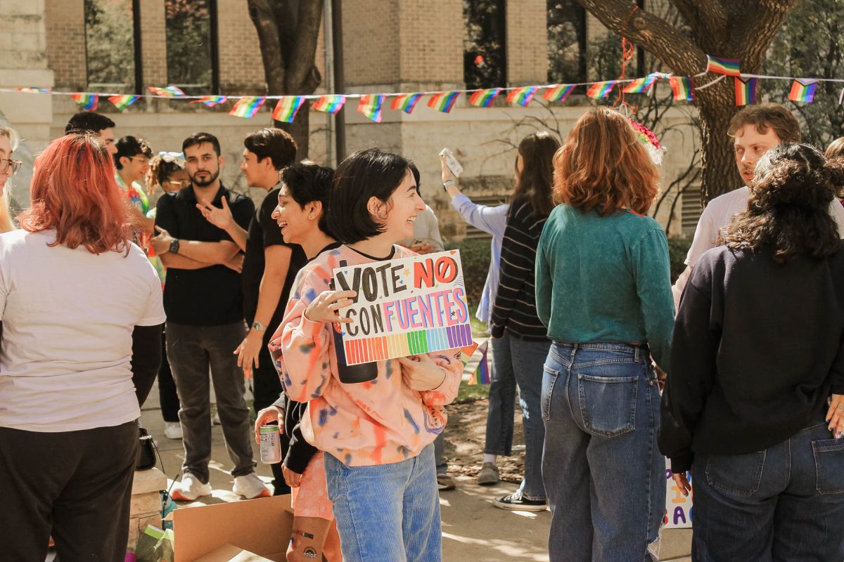 Students+gather+on+the+university+Seal+with+signs+displaying+call+to+actions.+Students+dance+around+to+pop+music+in+rainbow+attire+as+they+await+the+results+of+todays+Faculty+Senate+meeting.