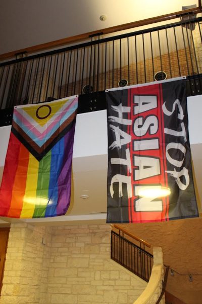 Residents at Basil Moreau Hall hang several flags in the building’s main lobby. Each flag represents different racial, ethnic and social identities that students are a part of.