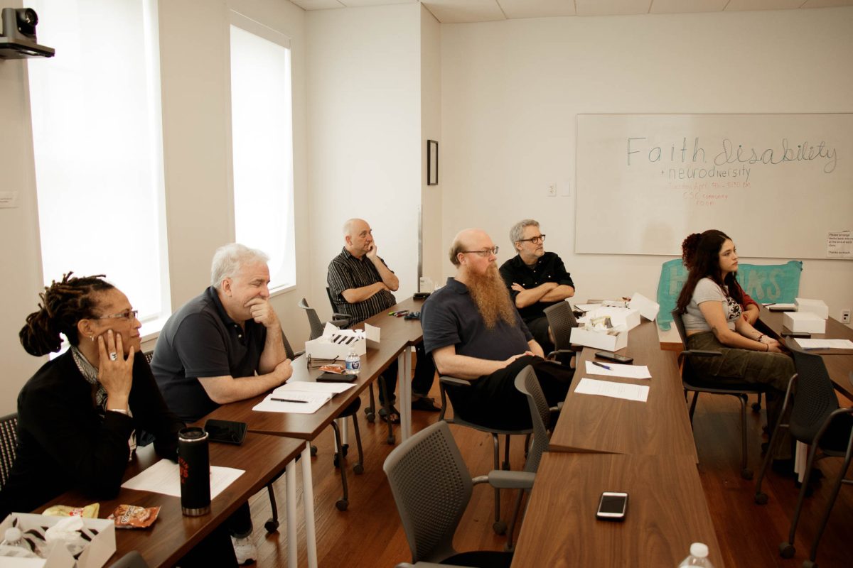 The audience watches and contemplates while Stansel gives her lecture. Of the professors present, three were from the Philosophy department, one from Video Game Development, and one from Communications. Food was provided for everyone present, but students were encouraged to take multiple boxes, as the food was intended for them.