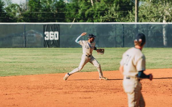 Senior infielder Josh Graham prepares to toss the ball to the second baseman. Graham, along with senior infielder Carlo Figueroa, was responsible for creating a 7-2 lead in the bottom of the fifth inning after a pinch hit.