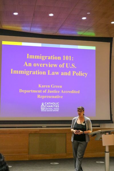 During the Know Your Rights workshop, Karen Green of Catholic Charities of Central Texas presents a slide explaining different immigration statuses. The presentation breaks down the spectrum from undocumented persons (those with expired visas or who entered without permission) to visa holders (both immigrant and non-immigrant categories), legal permanent residents (including conditional status) and U.S. citizens. 