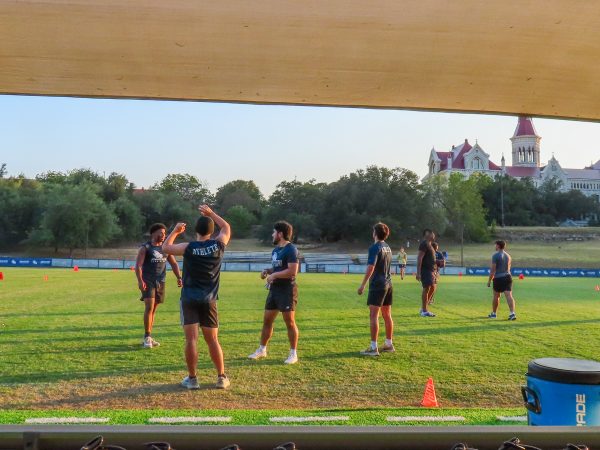 The flag football game warmup on the soccer field after the showcase. Players came from a variety of places, like club sports team members, visitors to the showcase, and even RecWell employees. 