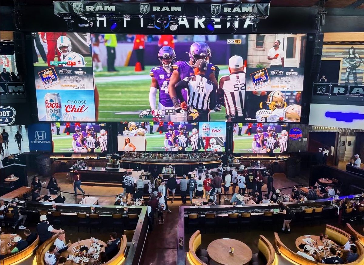 The game is showcased on a multiple of screens as fans gather to watch the playoffs unfold. 