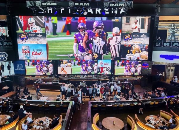 The game is showcased on a multiple of screens as fans gather to watch the playoffs unfold. 
